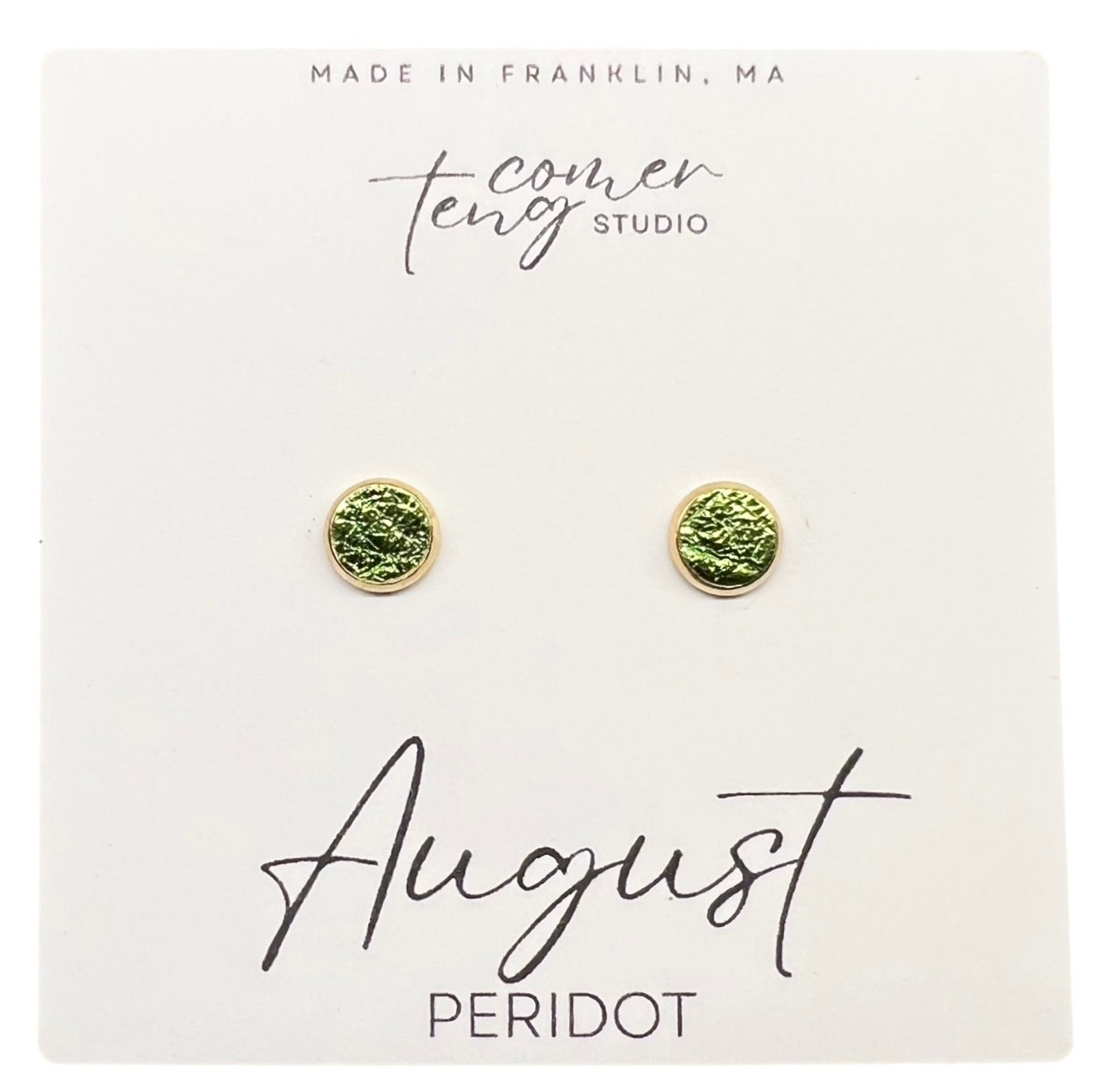 Pair of green earrings on a card with branding and "August Peridot"