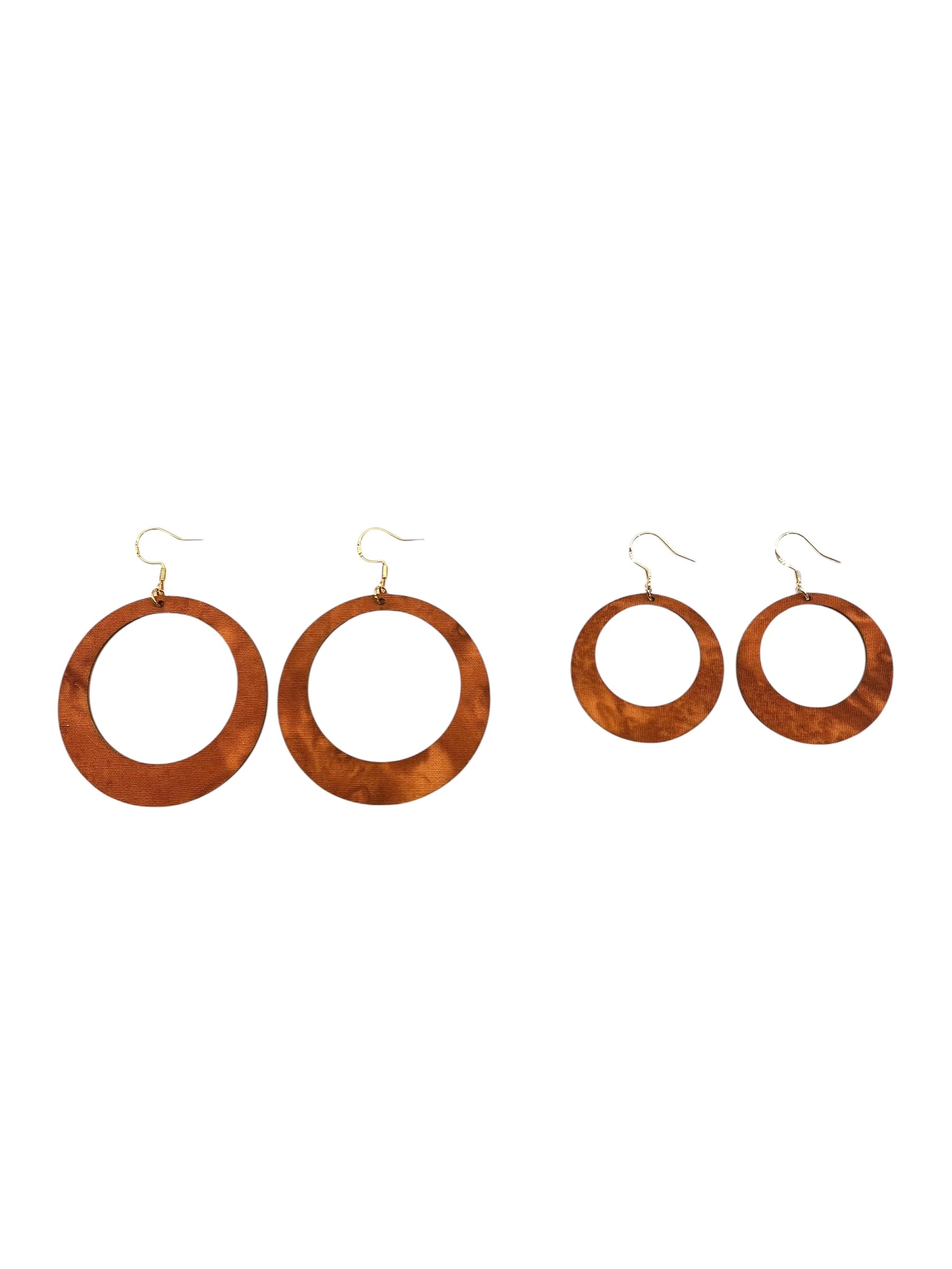 Set of four wooden hoop earrings on a white background