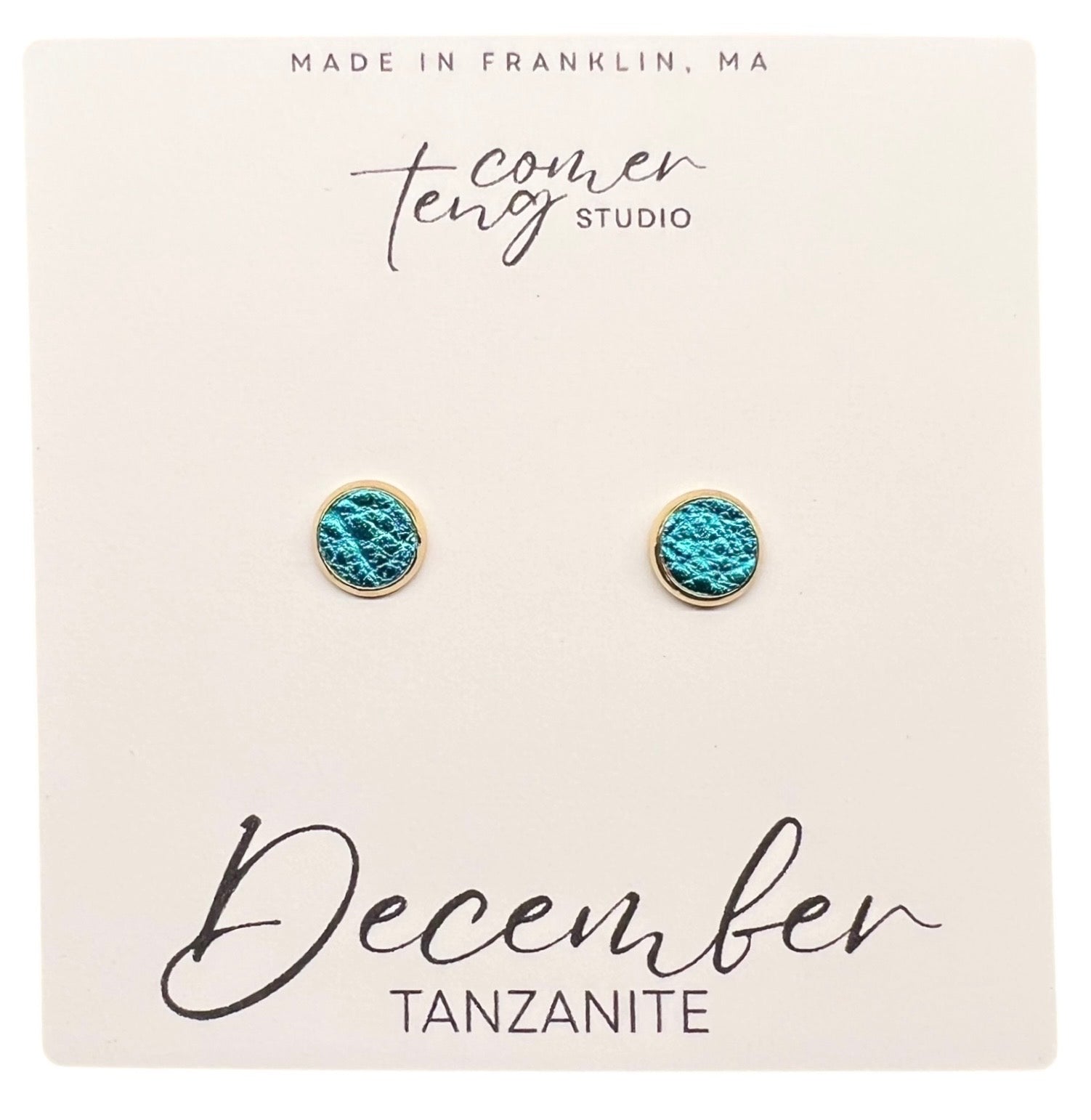 Turquoise earrings on a card branding and 'December Tanzanite' text.