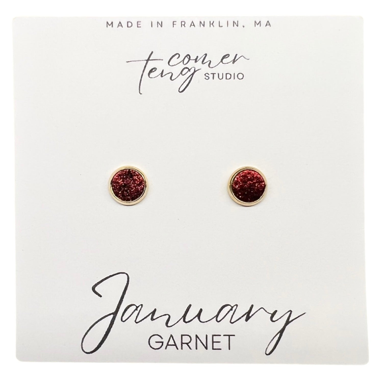 Garnet stud earrings on a card with branding and 'January Garnet' text.