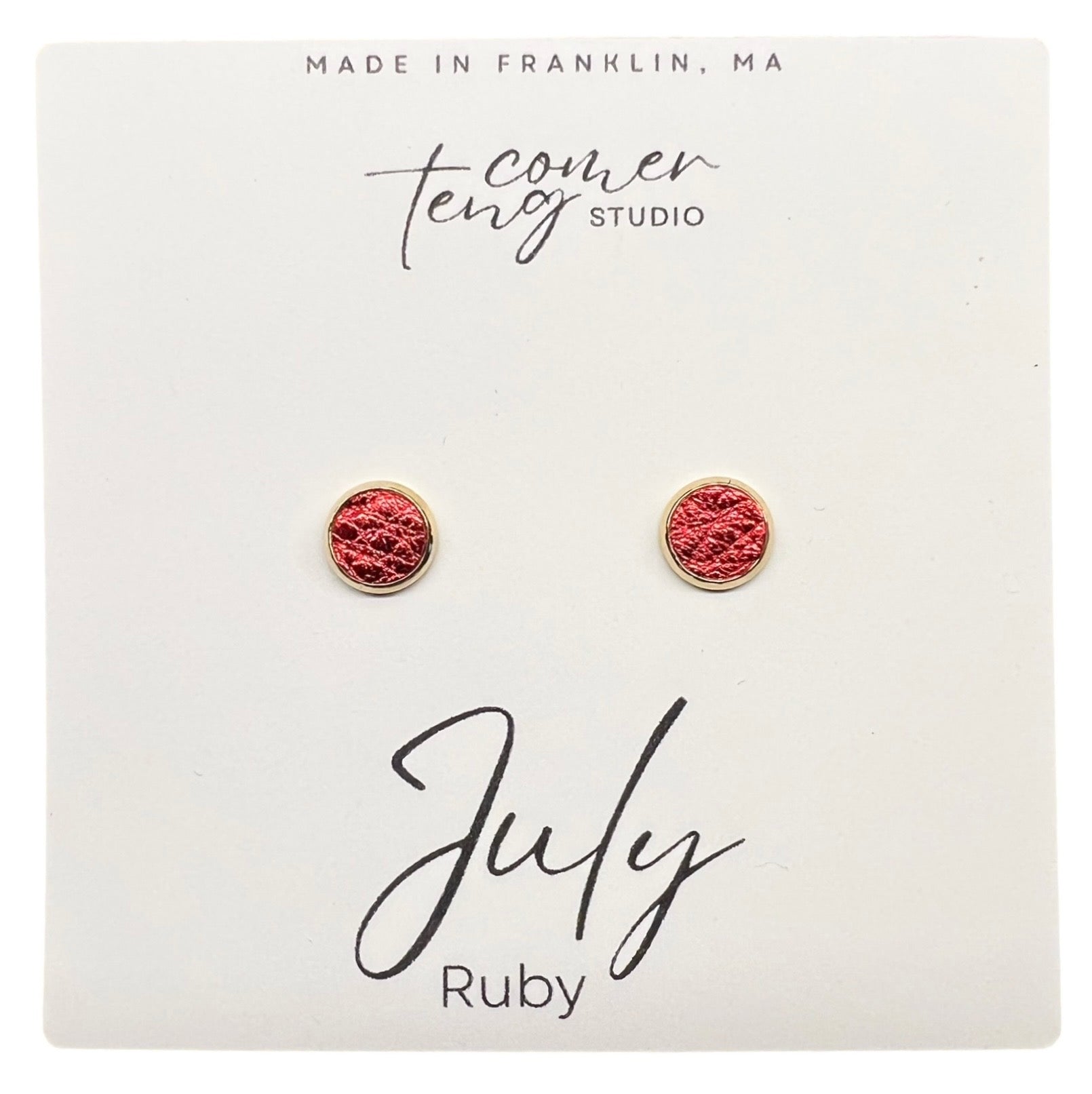 Pair of earrings on a card with branding and 'July Ruby' text.