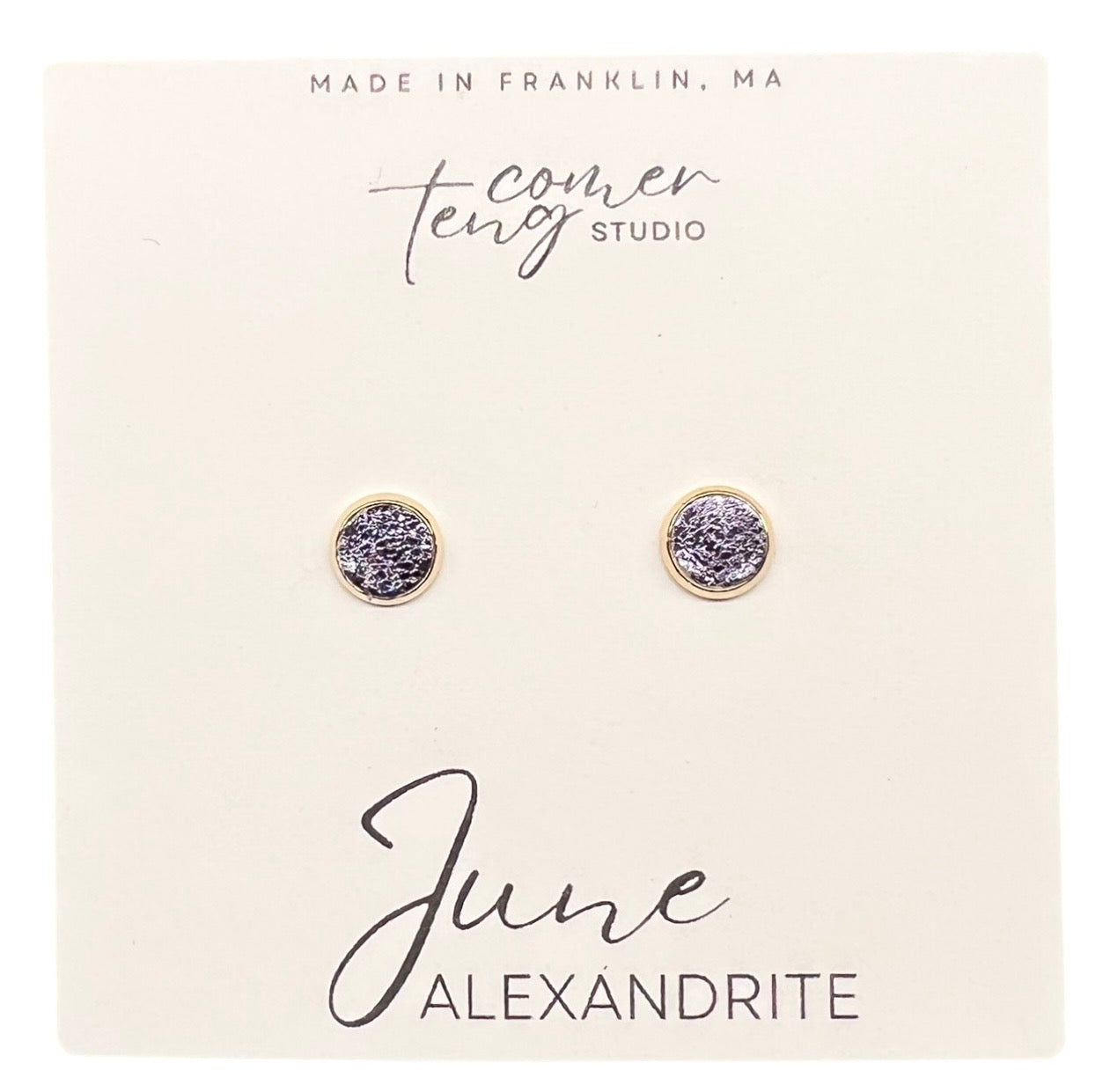 Pair of earrings on a card with 'June Alexandrite' text and branding.