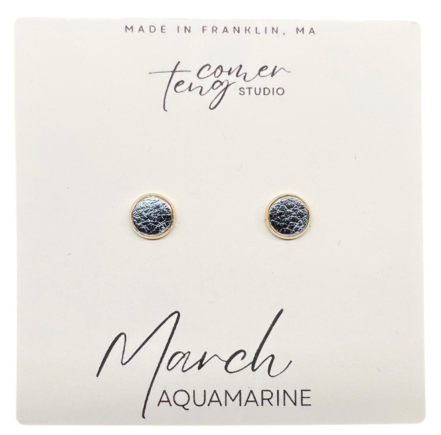 Pair of earrings on a card with branding and 'March Aquamarine' text.