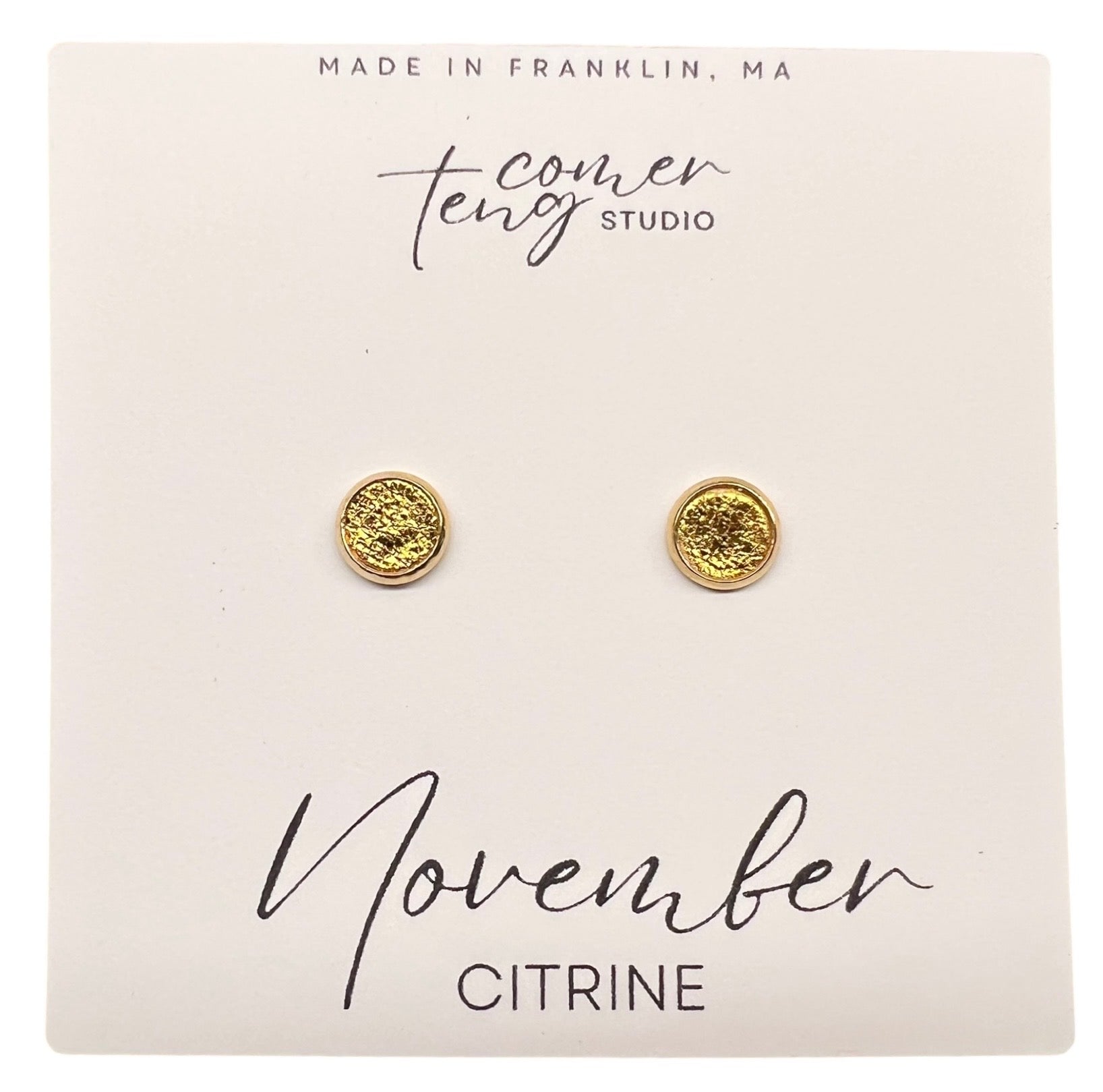 Gold earrings on a card with 'November Citrine' text and branding.