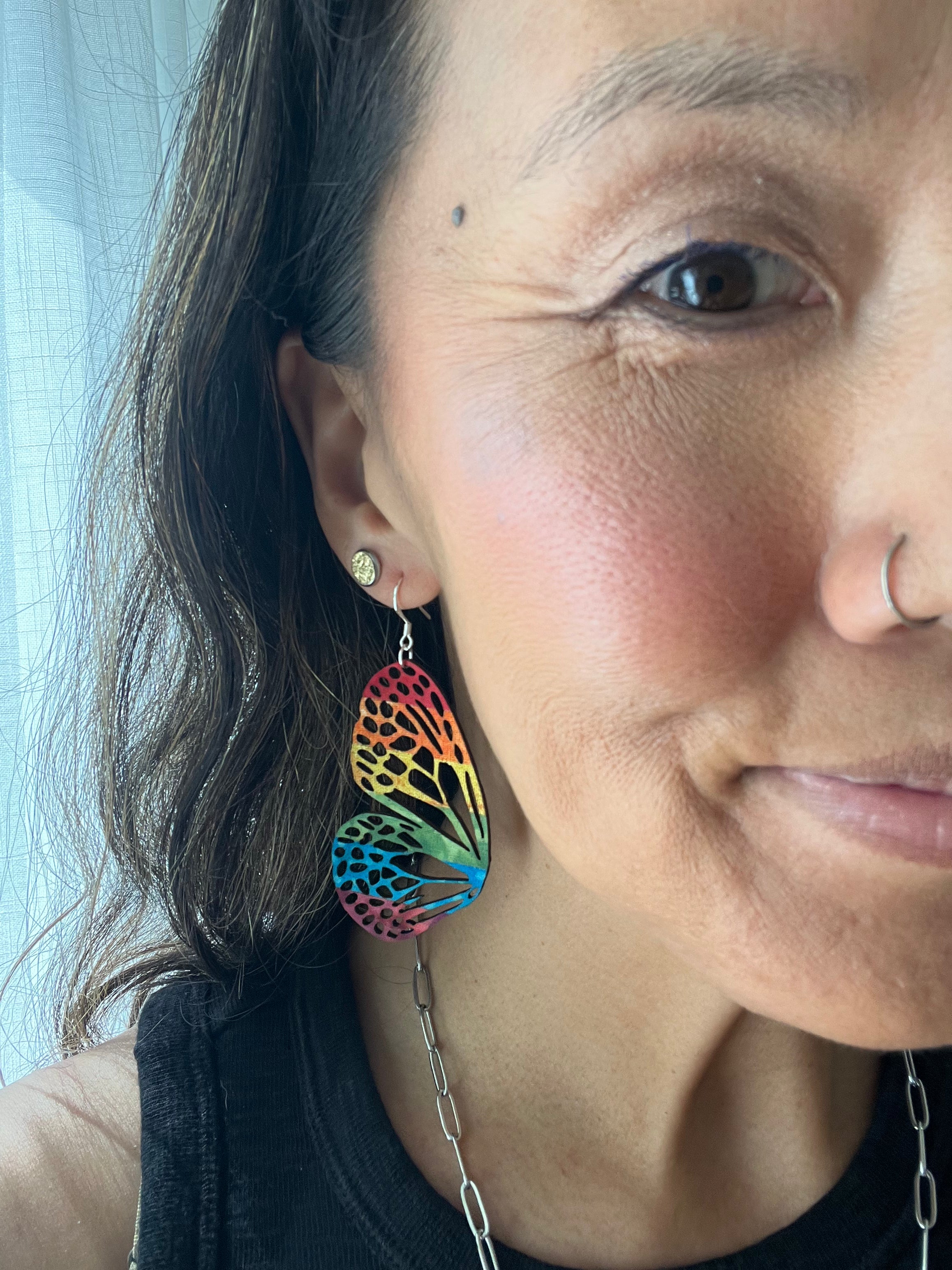 Close-up of PT wearing colorful earrings,