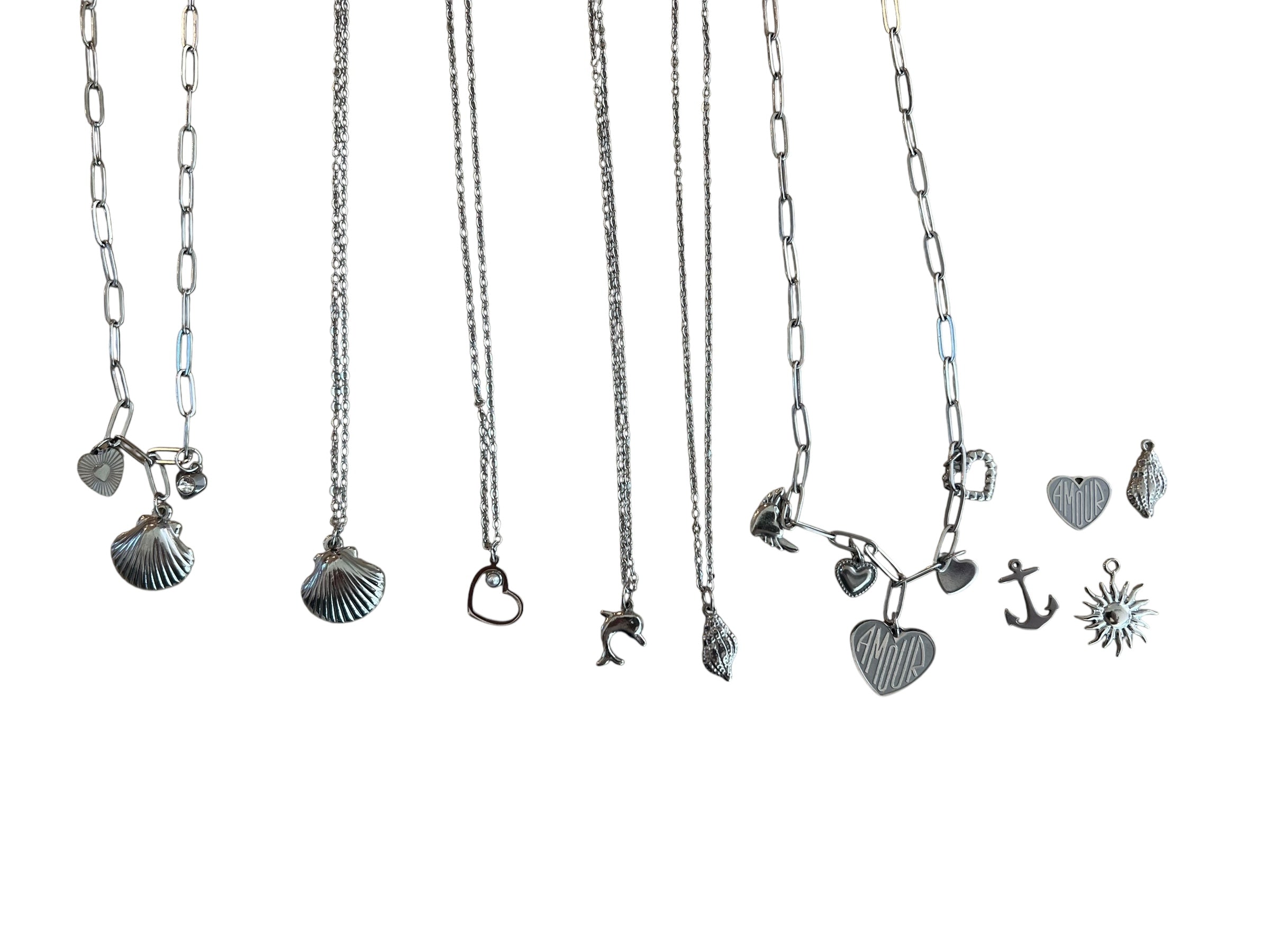 Collection of silver necklaces with various pendants on a white background