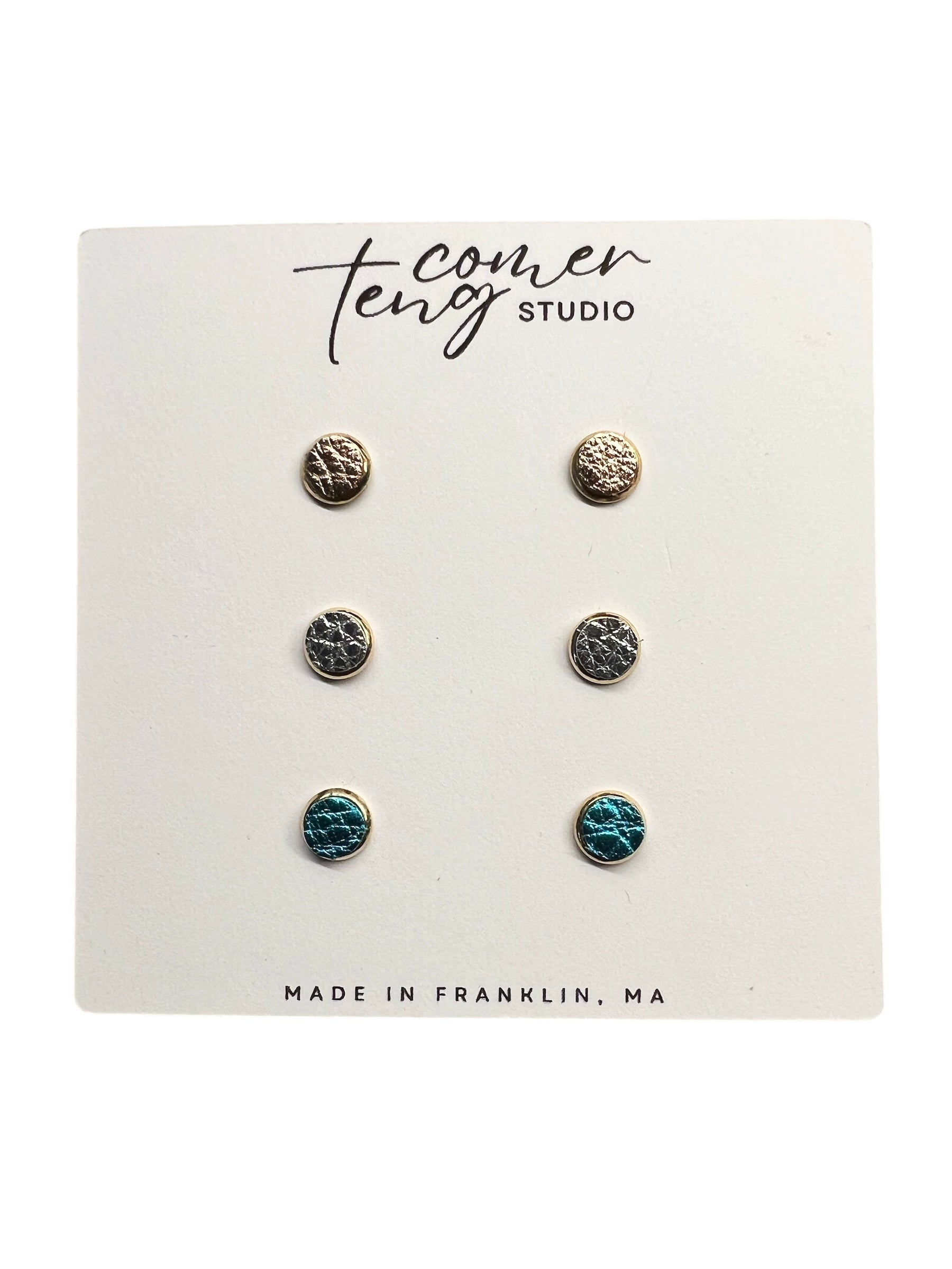 Set of 3 mini earring sets on a card .