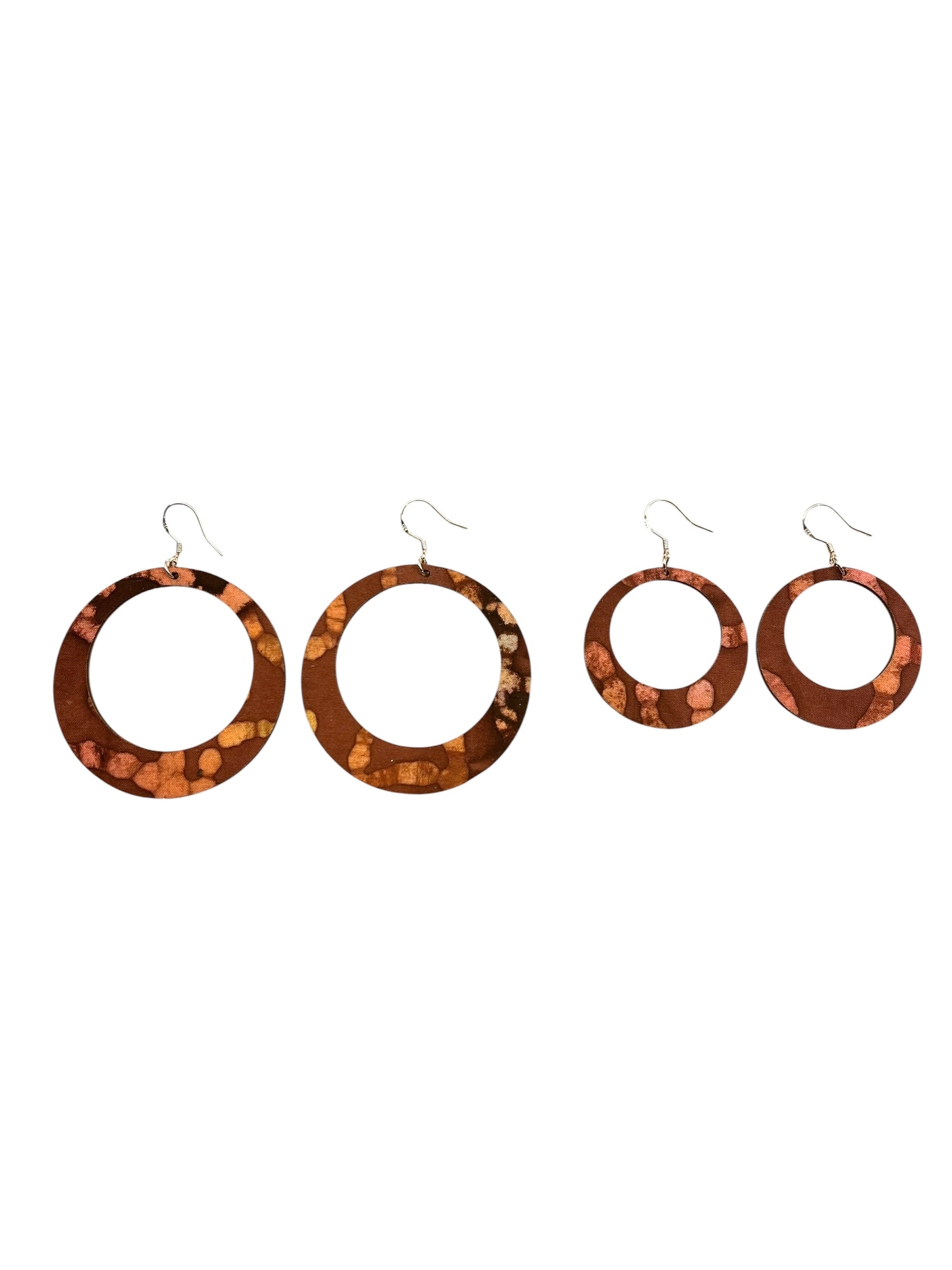 Set of four tortoiseshell hoop earrings on a white background