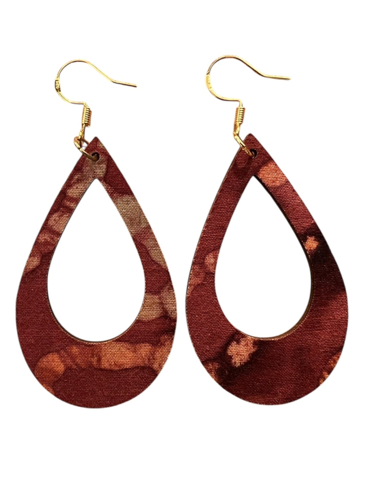 Wooden teardrop earrings with gold hooks on a white background