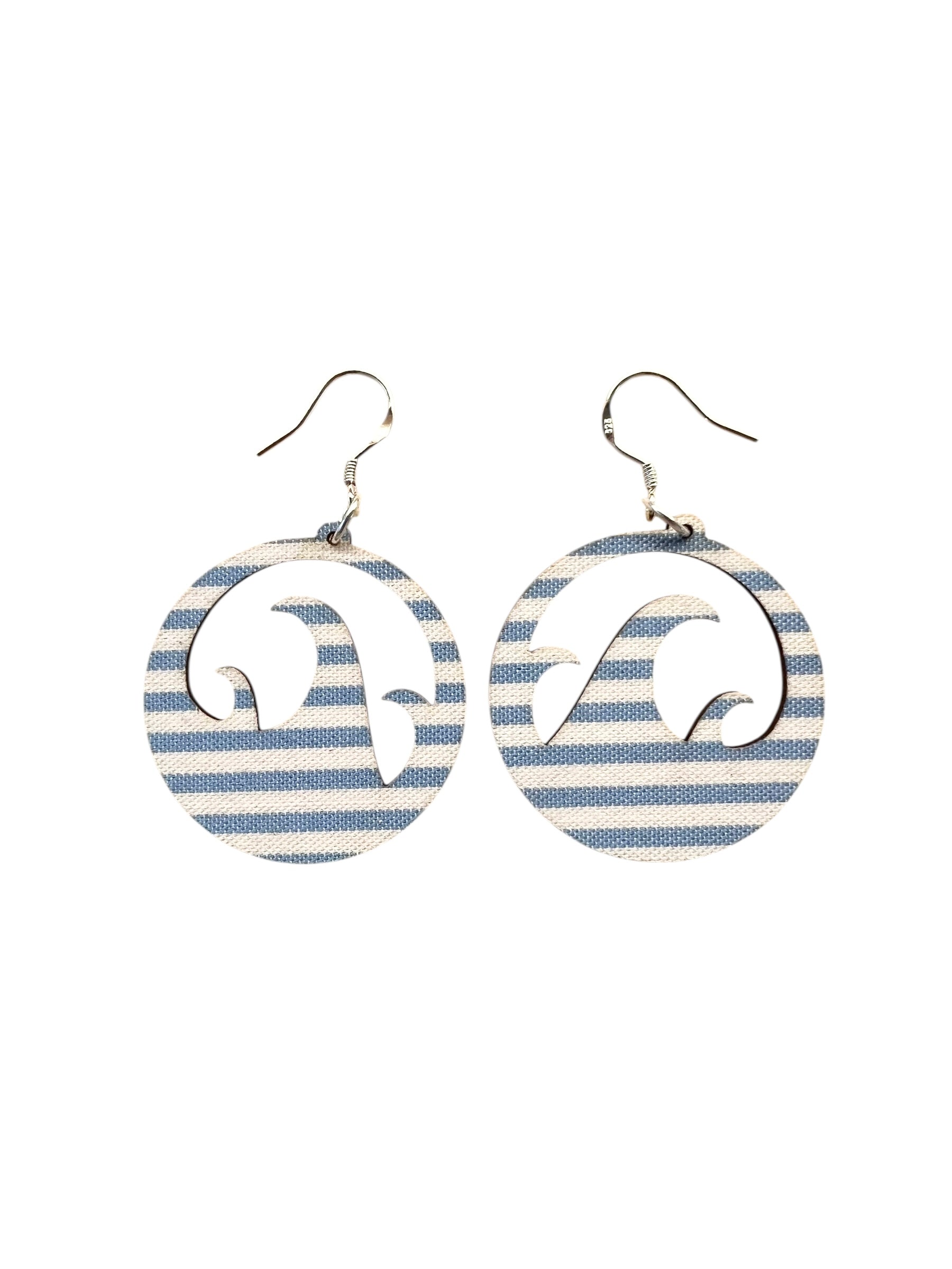 Pair of earrings with wave design on striped background