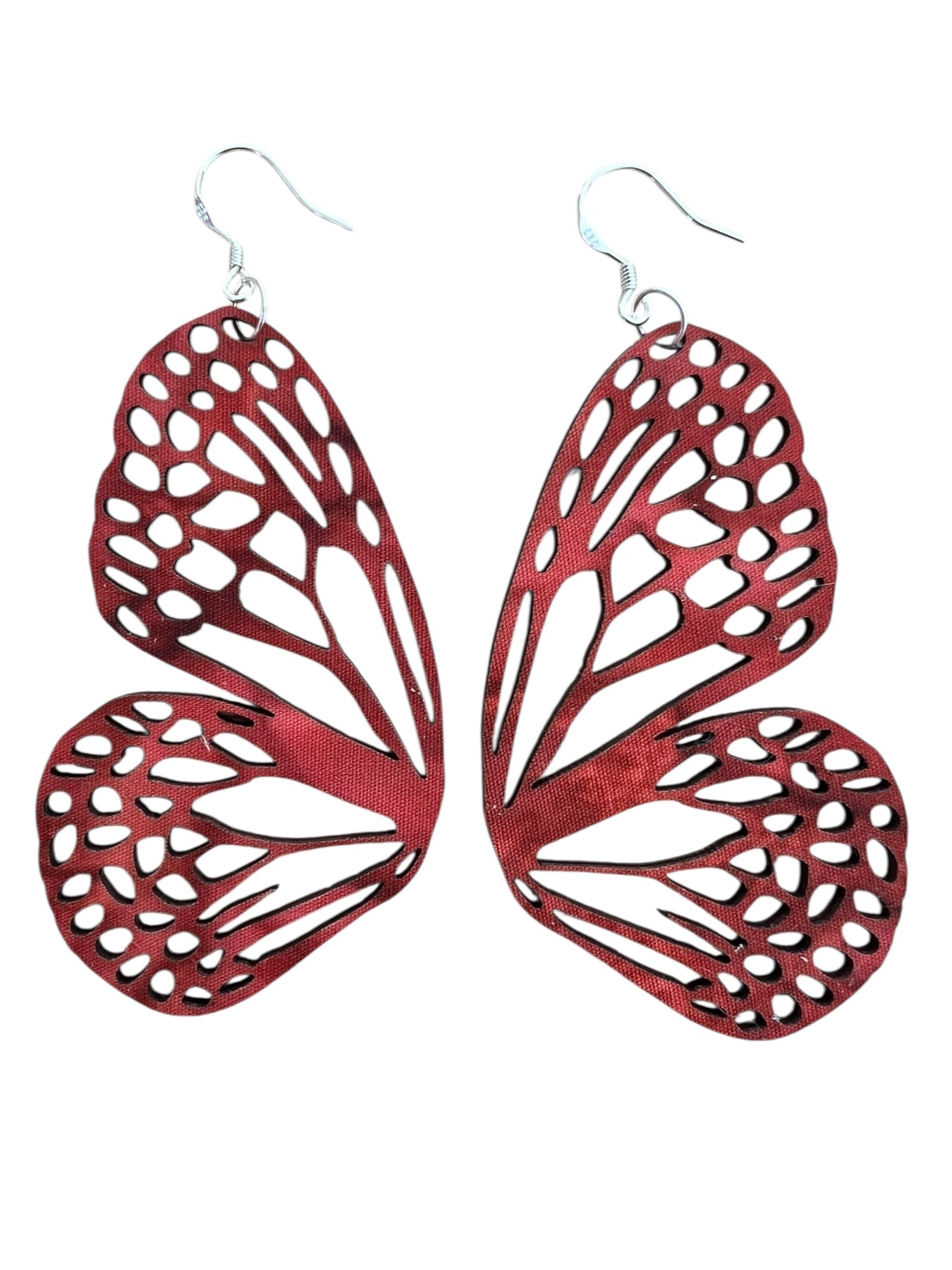 Red butterfly-shaped earrings on a white background
