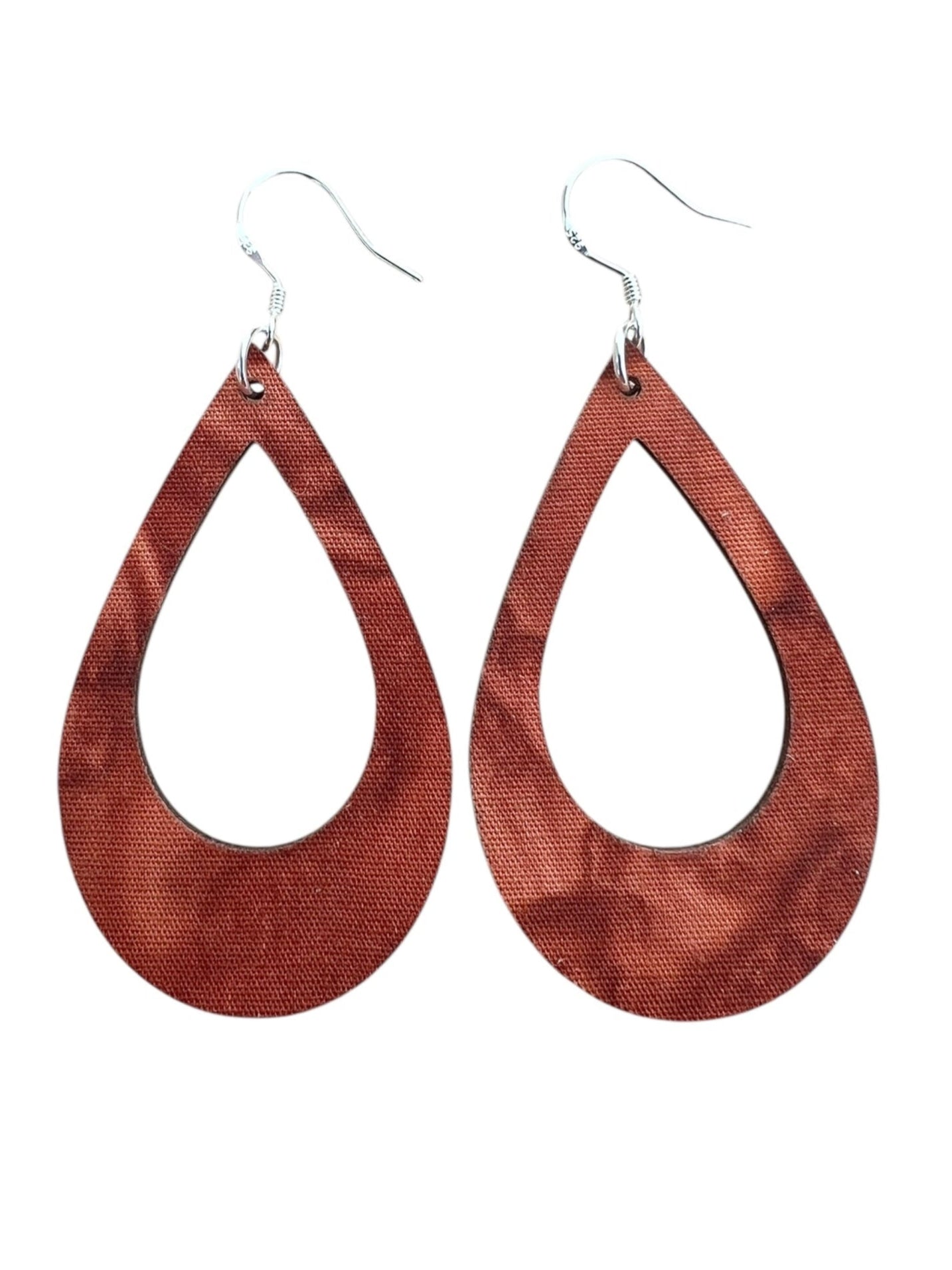 Teardrop-shaped wooden earrings on a white background
