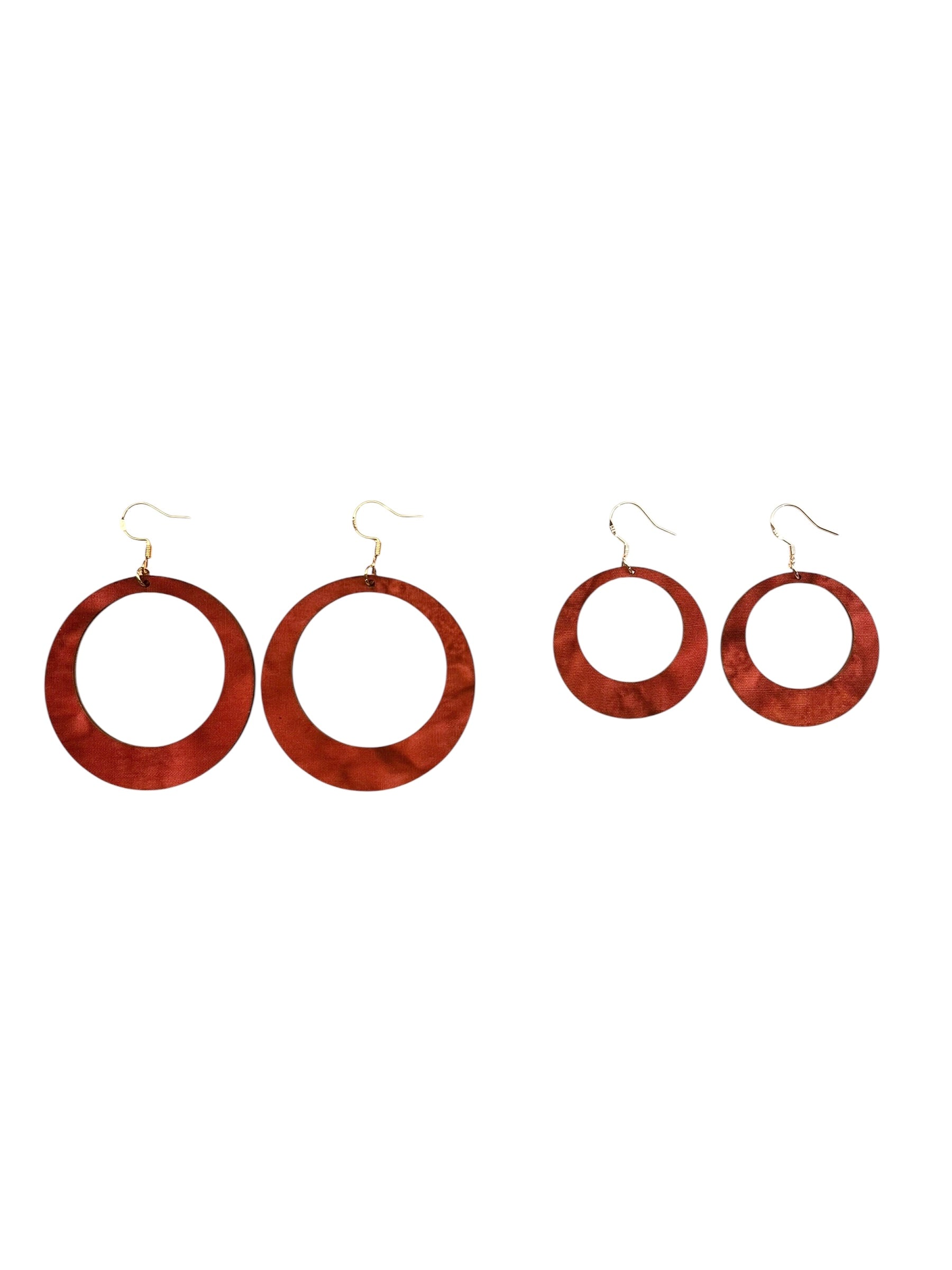 Set of four wooden hoop earrings on a white background