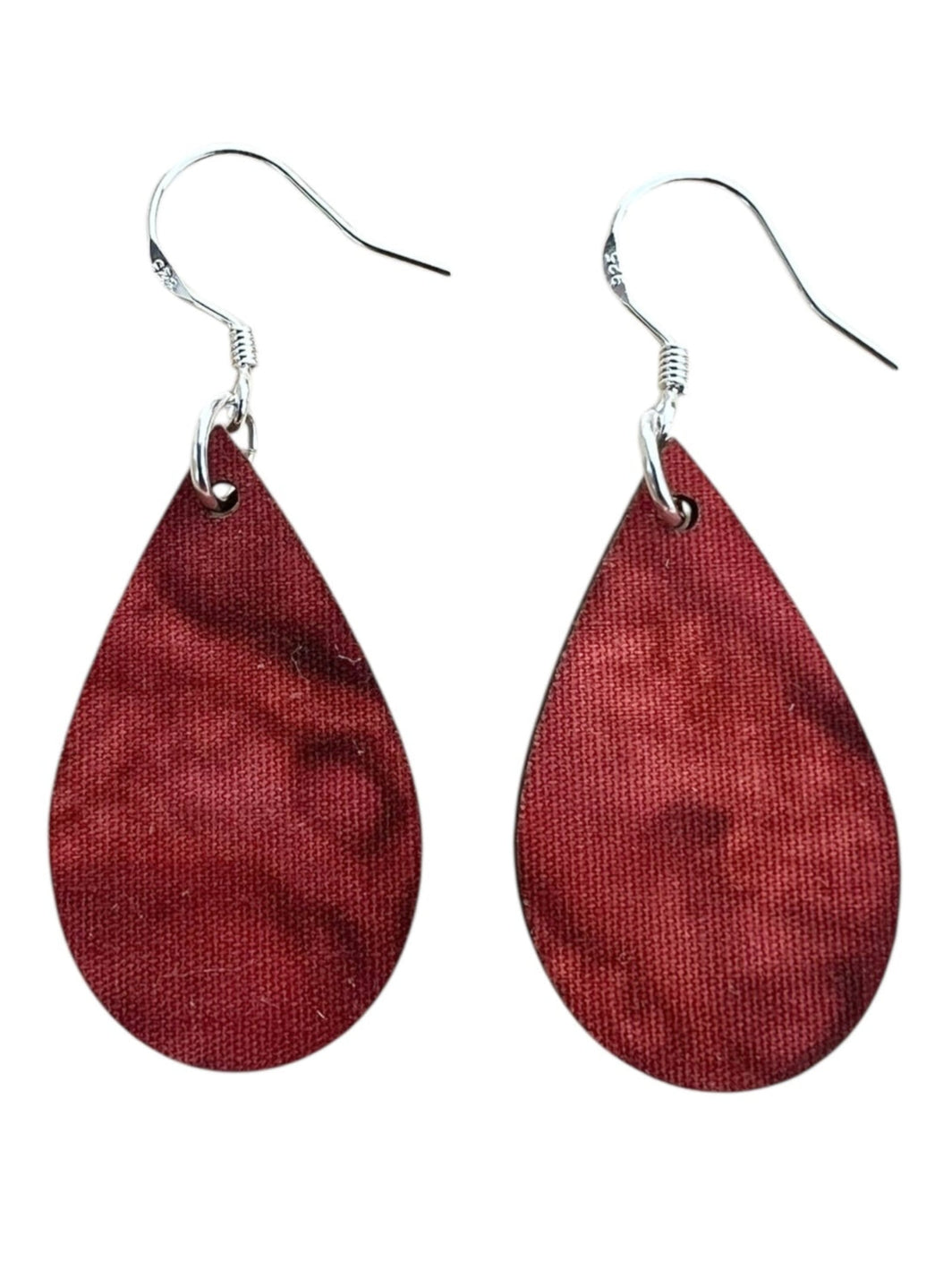 Red teardrop-shaped earrings on a white background