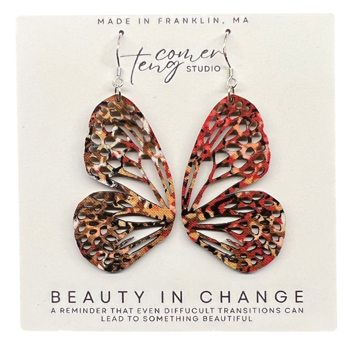Pair of earrings on a card with Beauty and Change.