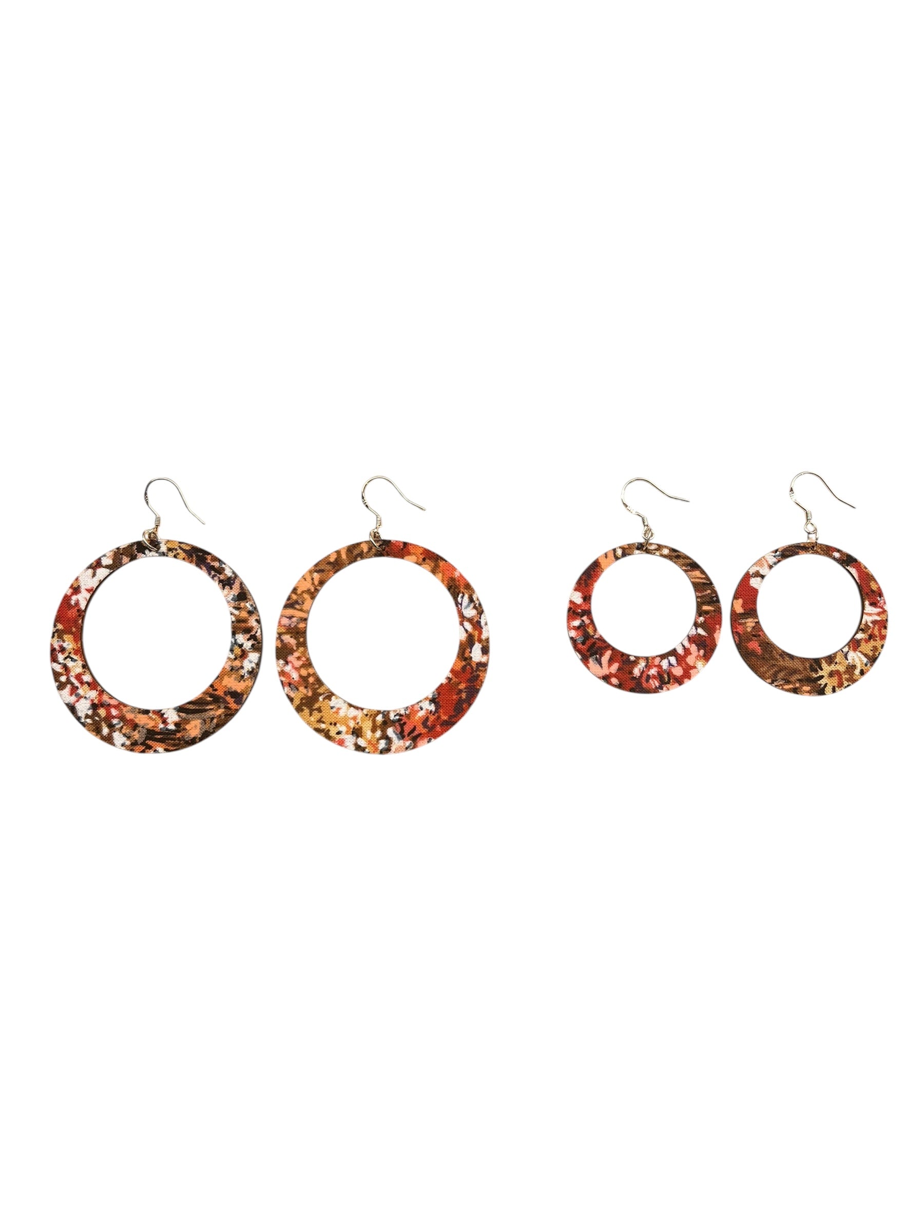 Set of four floral hoop earrings on a white background