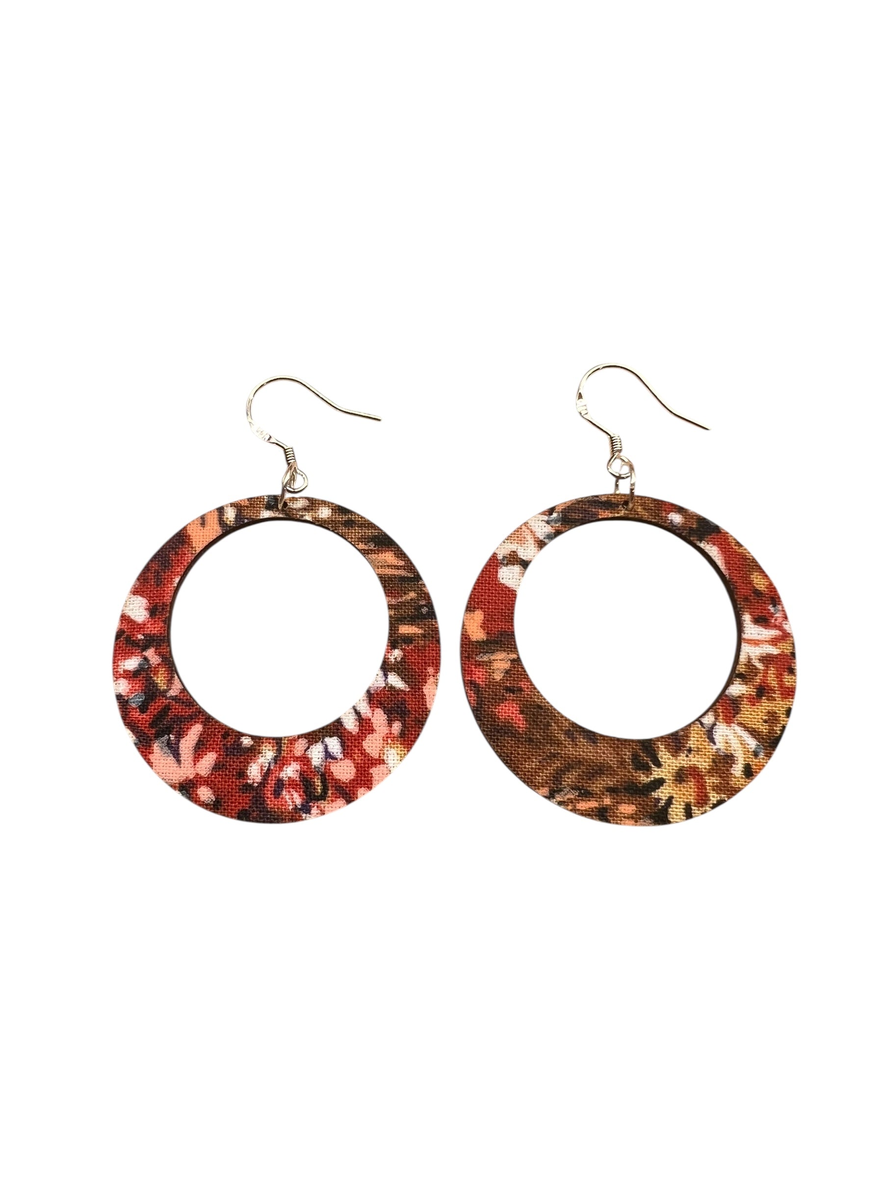 Pair of round hoop earrings with a multicolored pattern on a white background
