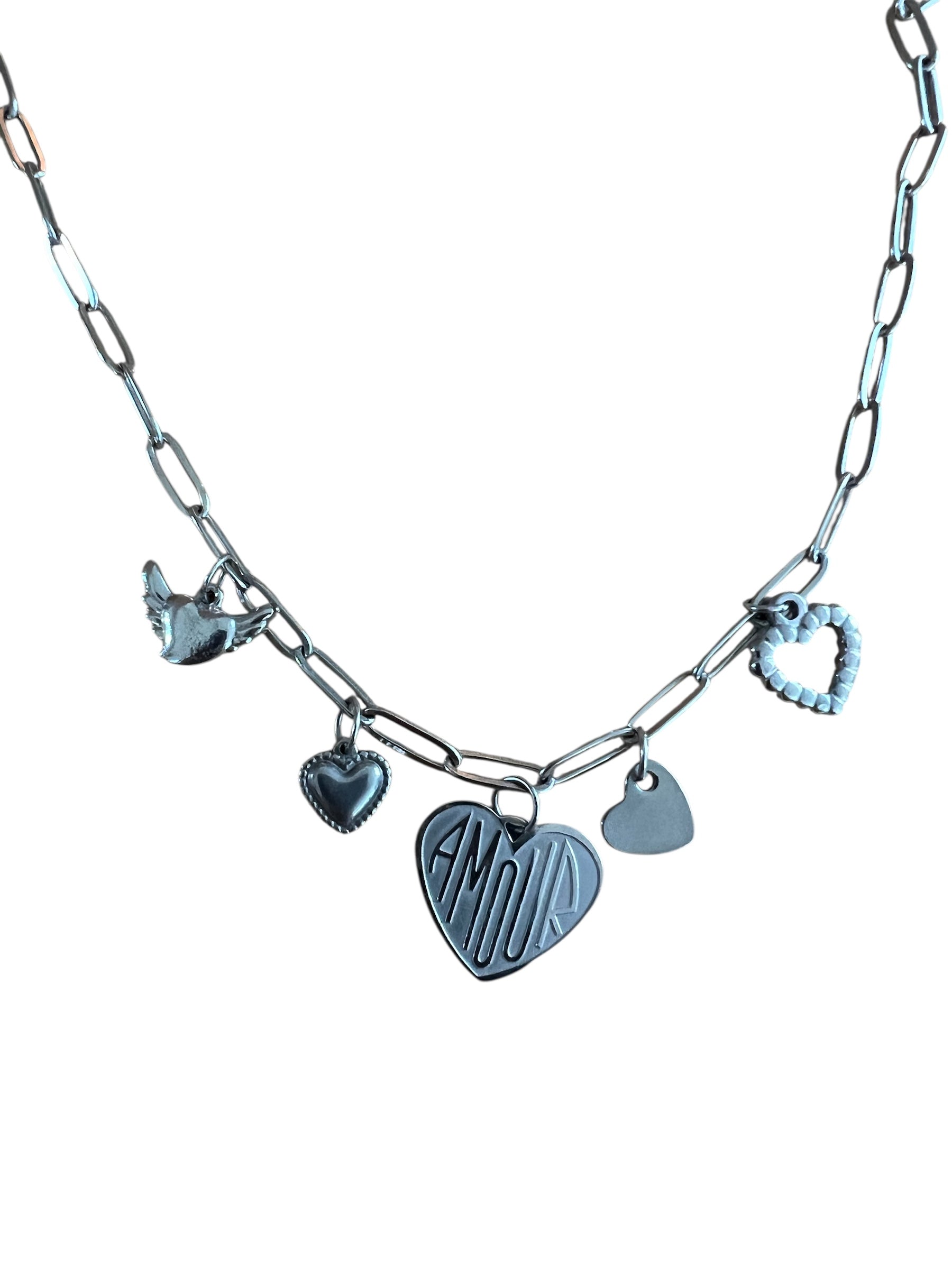 Silver necklace with heart-shaped charms on a white background