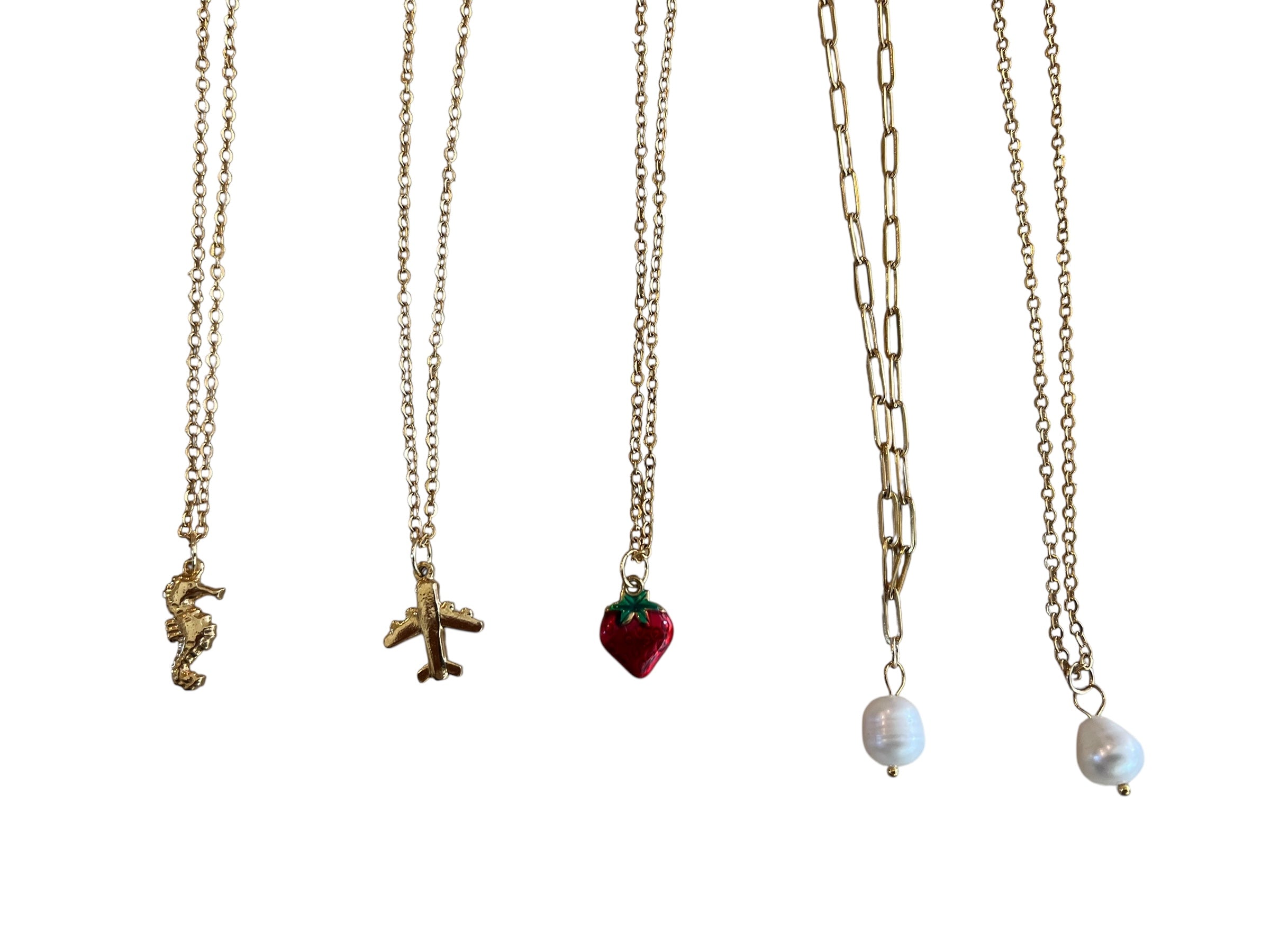 Five gold necklaces with various pendants on a white background