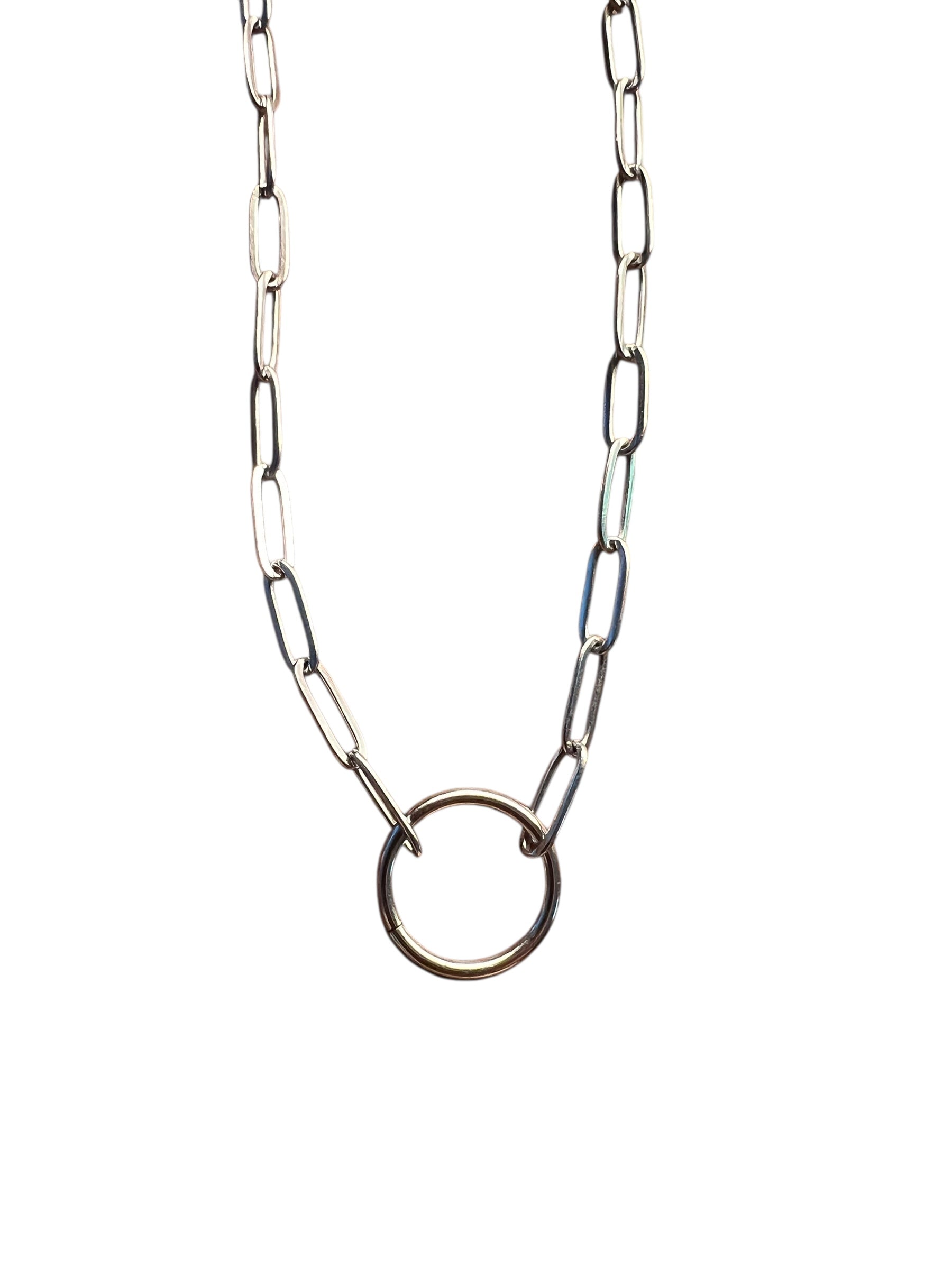 Silver chain necklace with a circular pendant on a white background