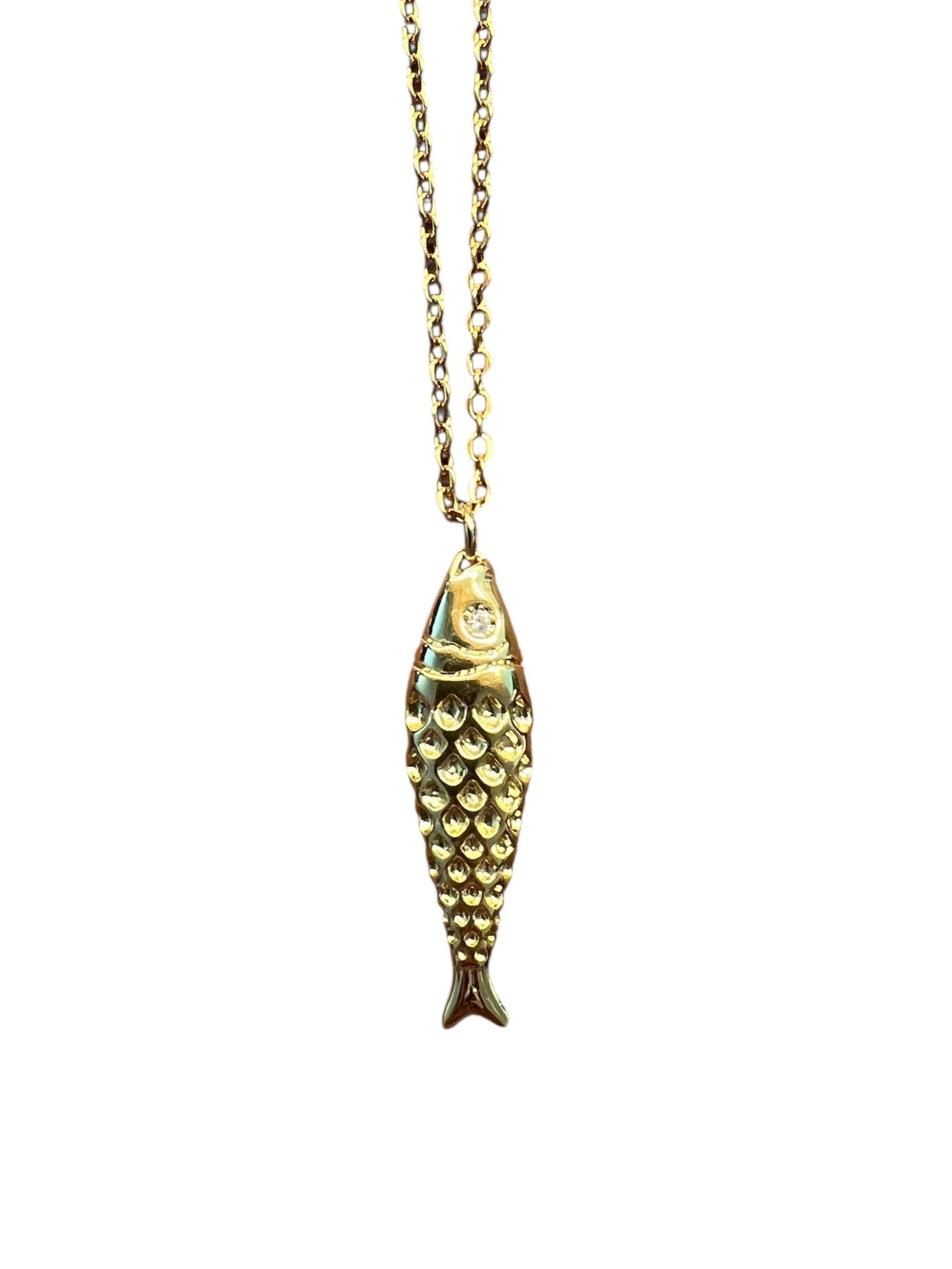 Gold fish-shaped pendant on a chain against a white background