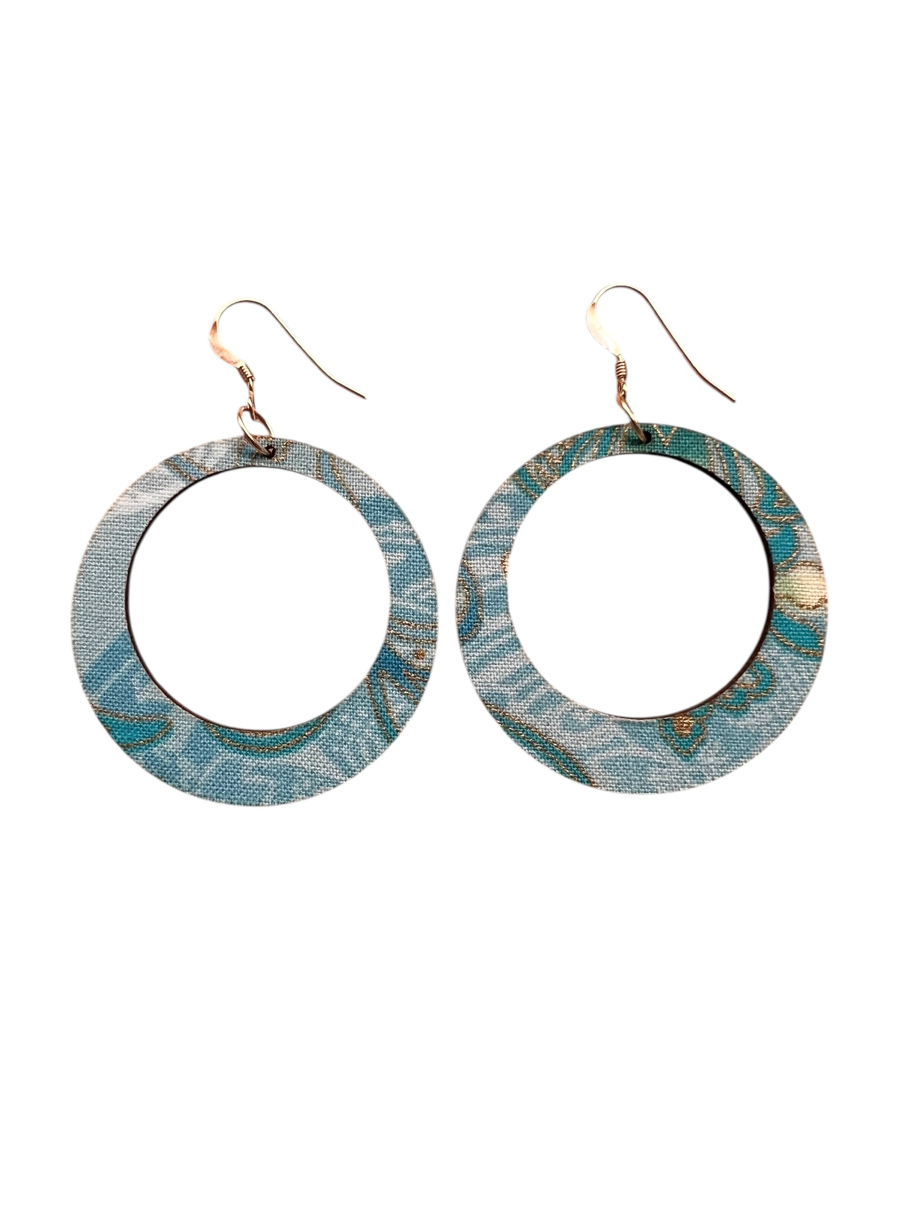Pair of hoop earrings with blue and green pattern on a white background