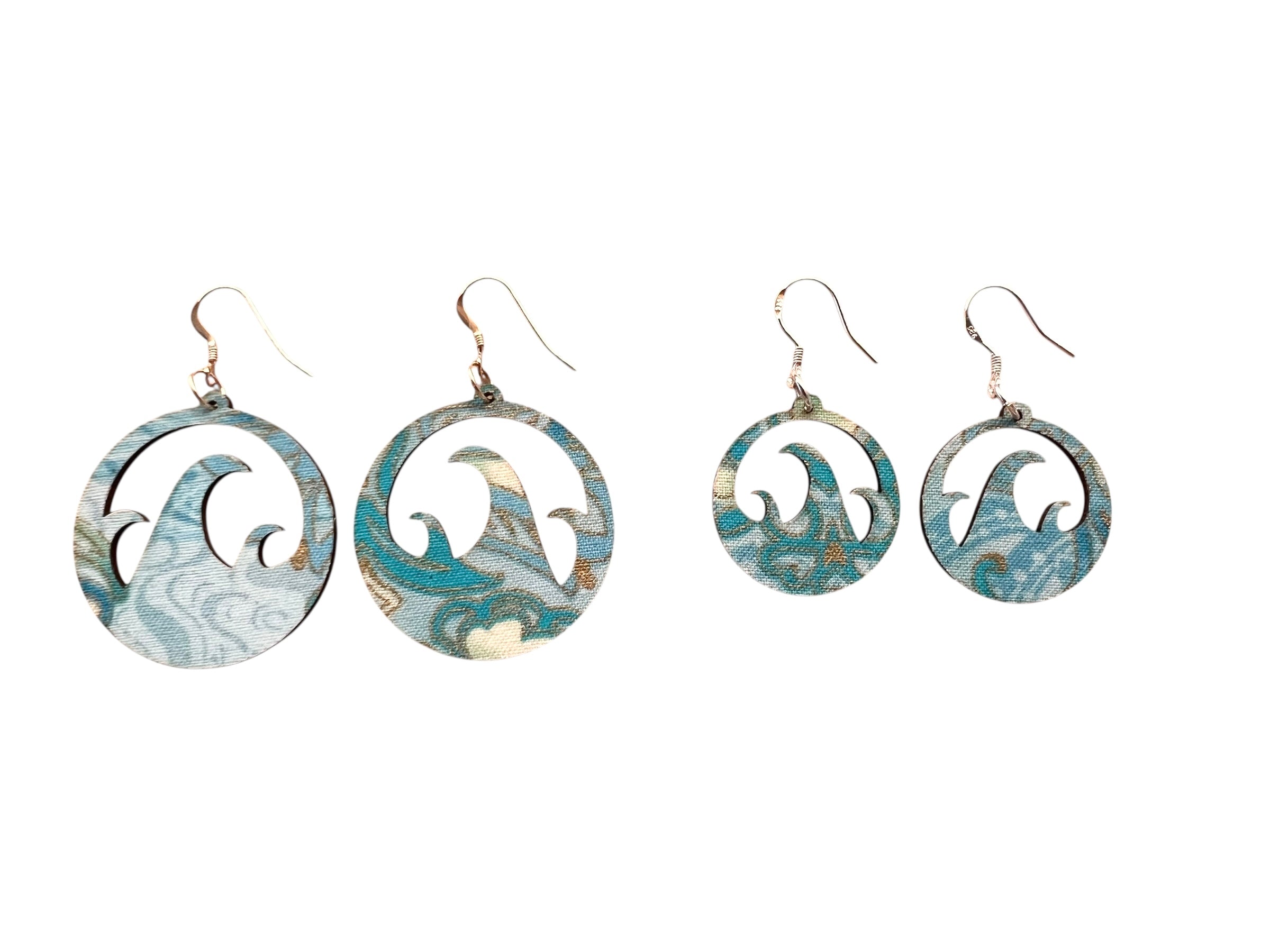 Set of four earrings with wave design on a white background
