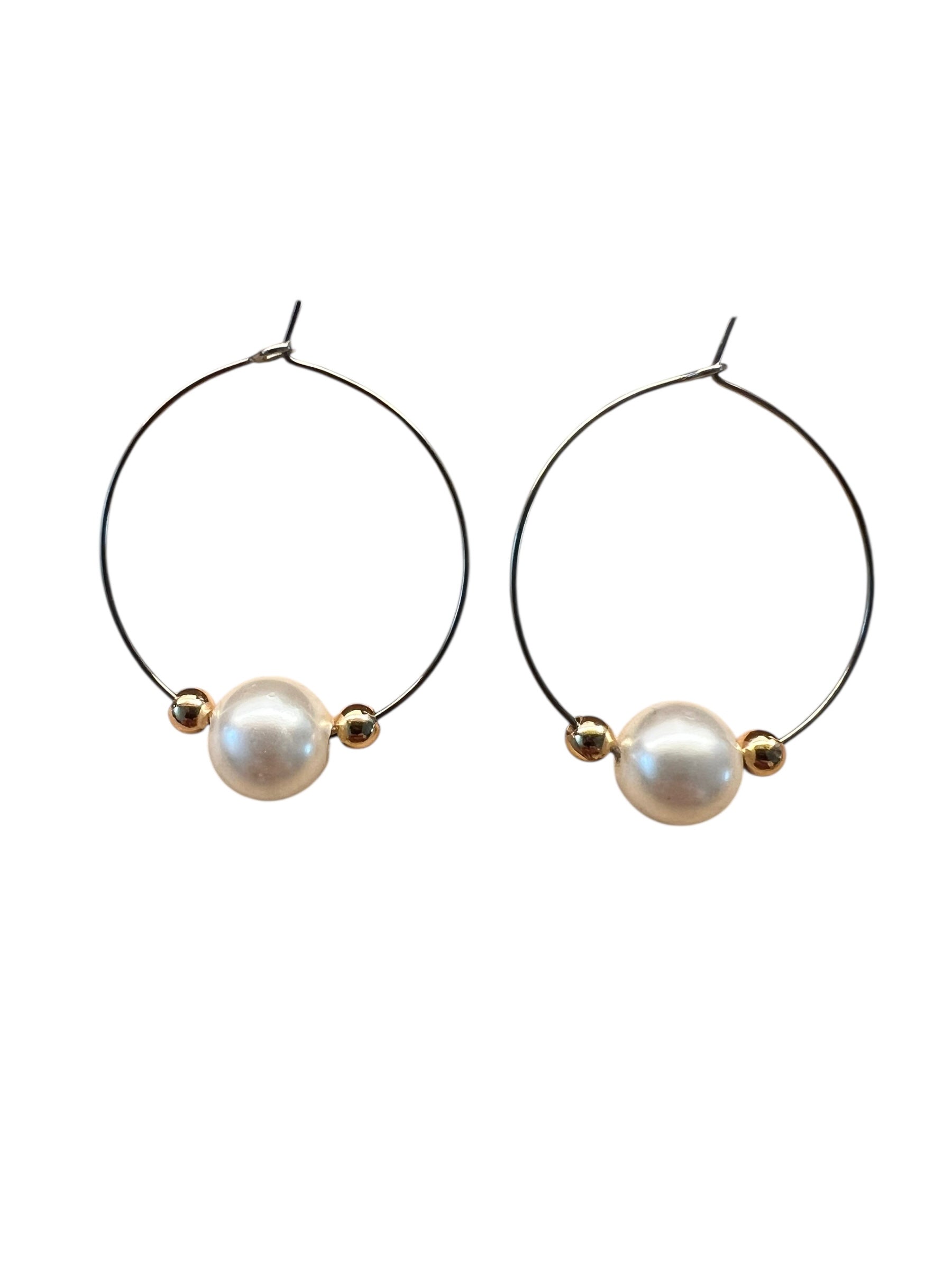 Pair of hoop earrings with pearls on a white background