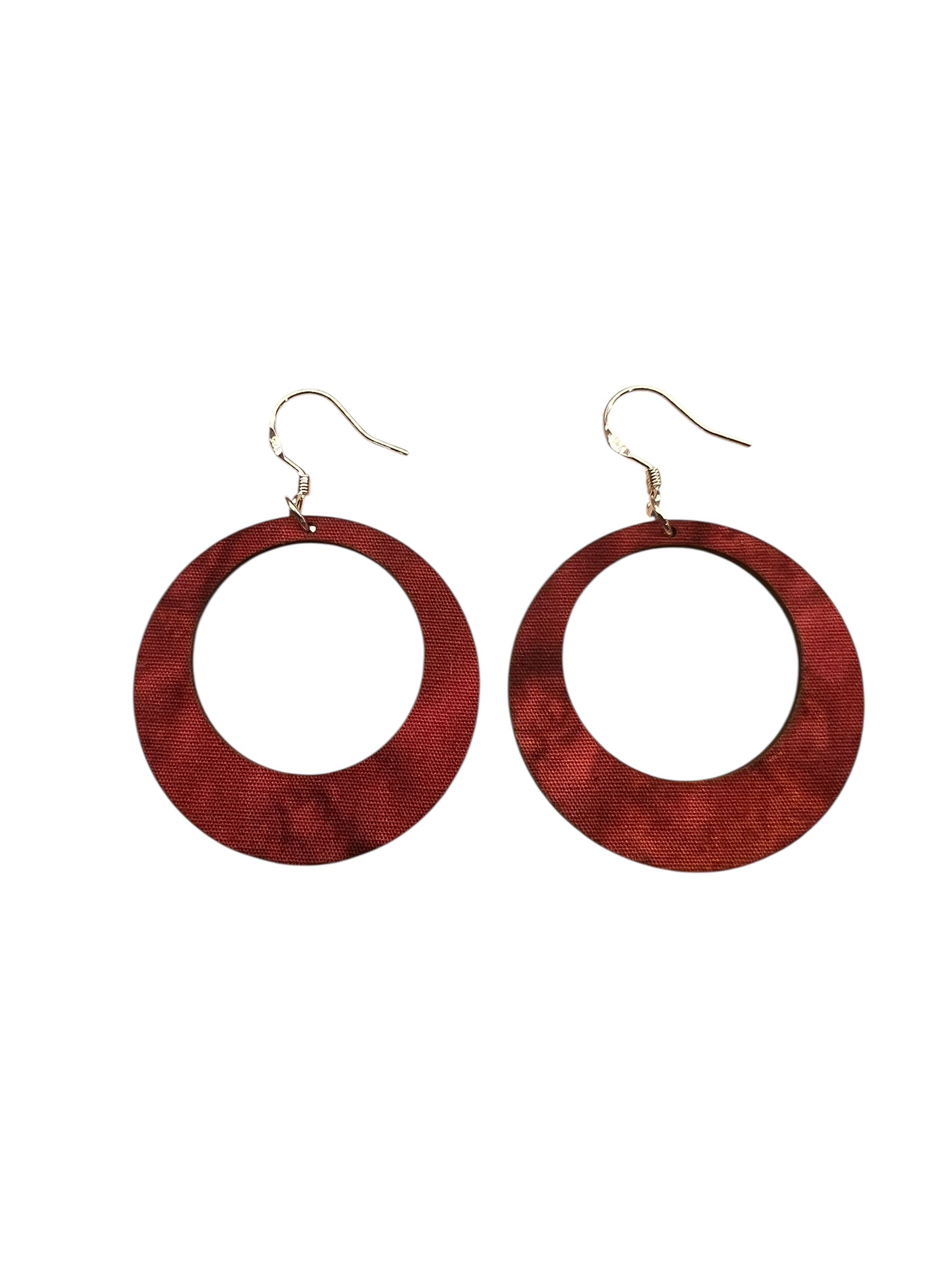 Red hoop earrings on a white background