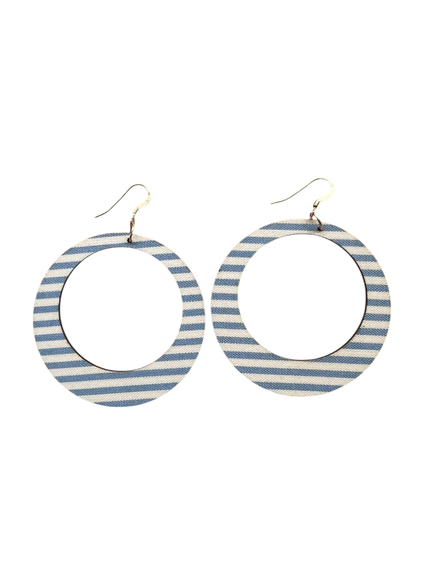 Pair of hoop earrings with blue and white striped design on a white background