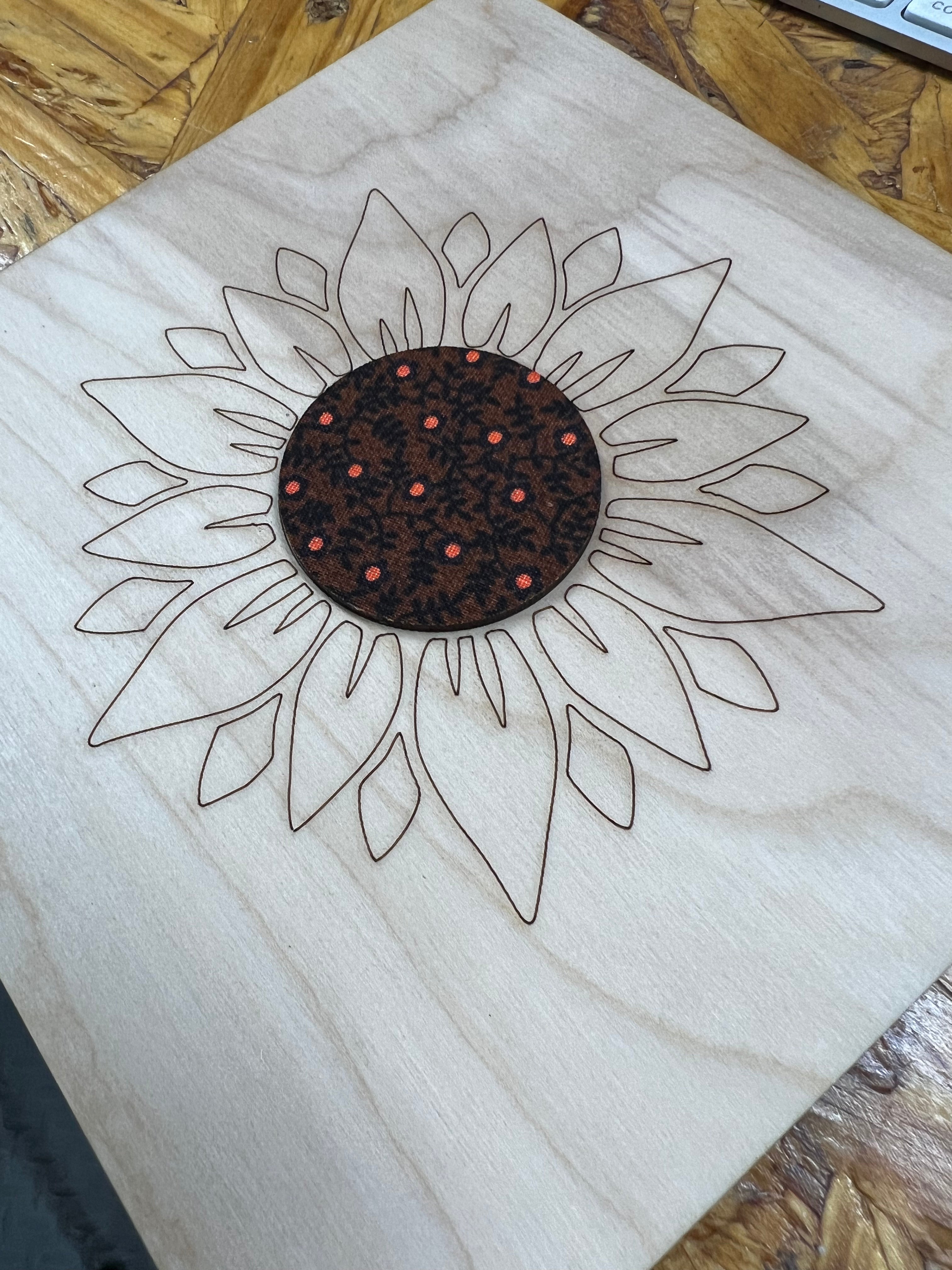 Design of a sunflower on wood with a wooden surface in the background