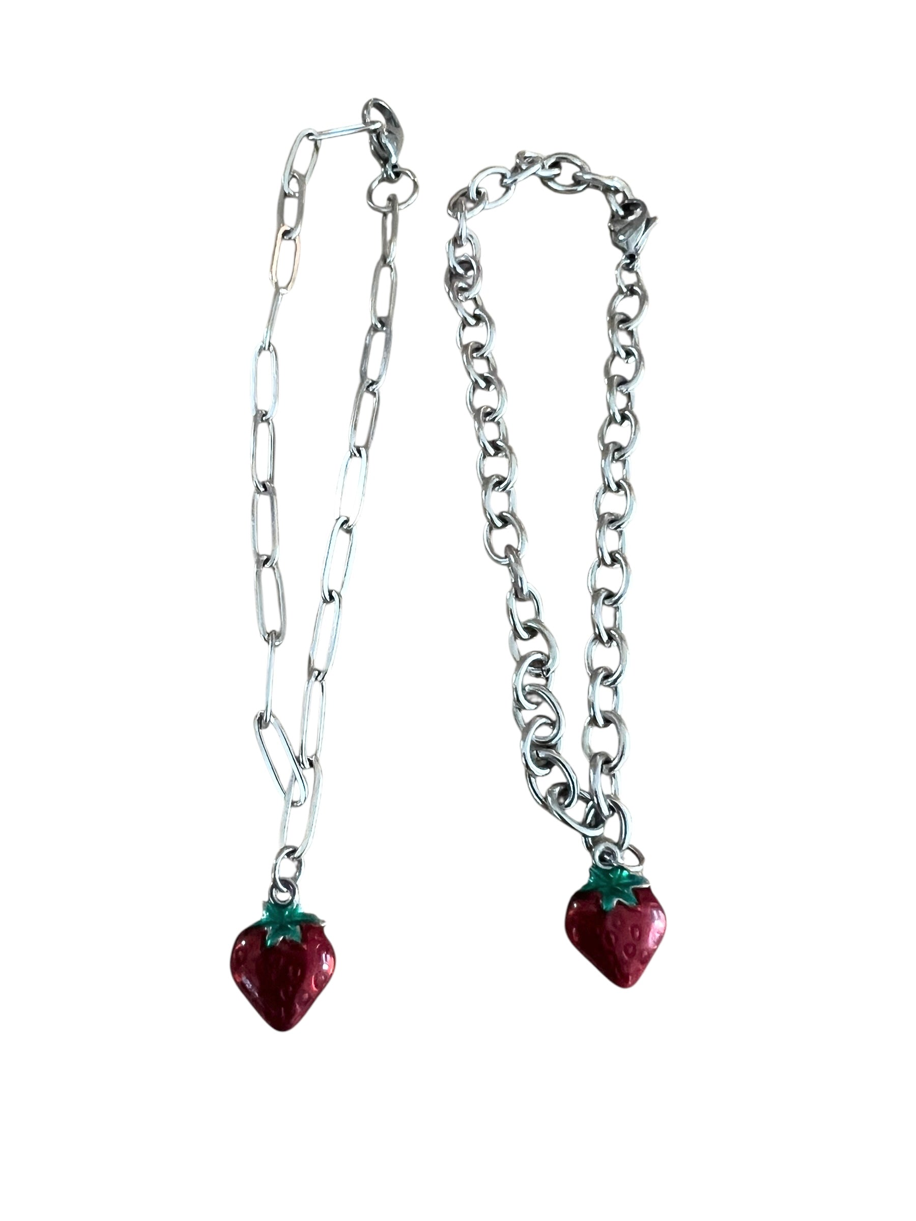 Two silver chain necklaces with strawberry-shaped charms on a white background